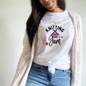 woman with a white t-shirt that says knitting is my jam